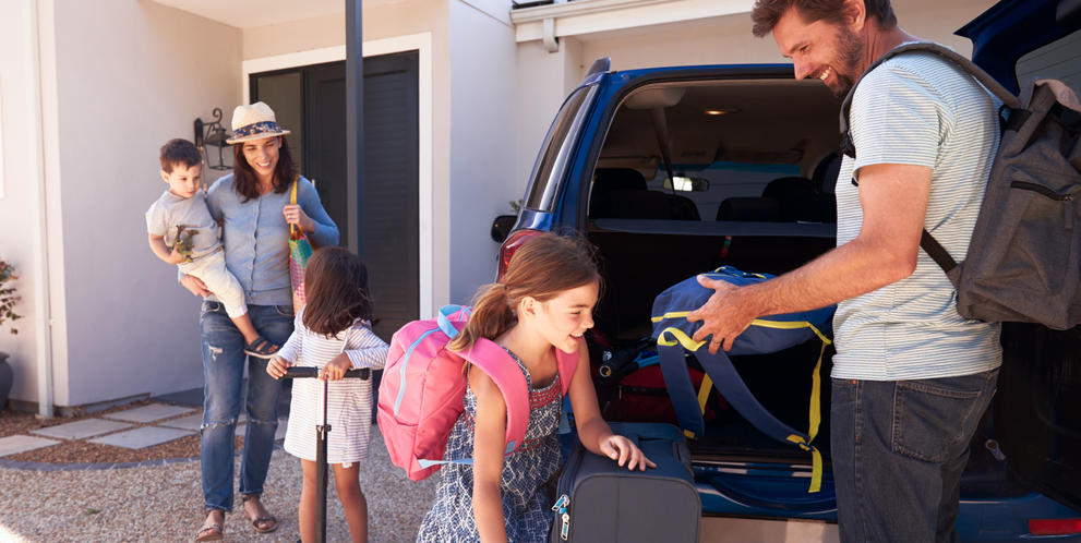 Family packing the car for a holiday