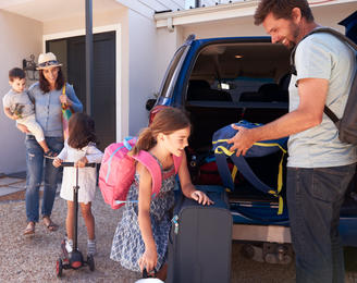 Family packing the car for a holiday